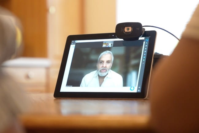 A provider is seen on video on a tablet.
